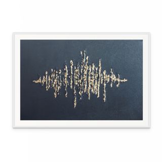 Framed artwork with a gold abstract design on a blue background