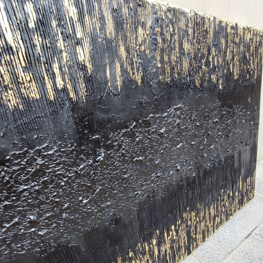 Close up of Black and gold textured painted canvas
