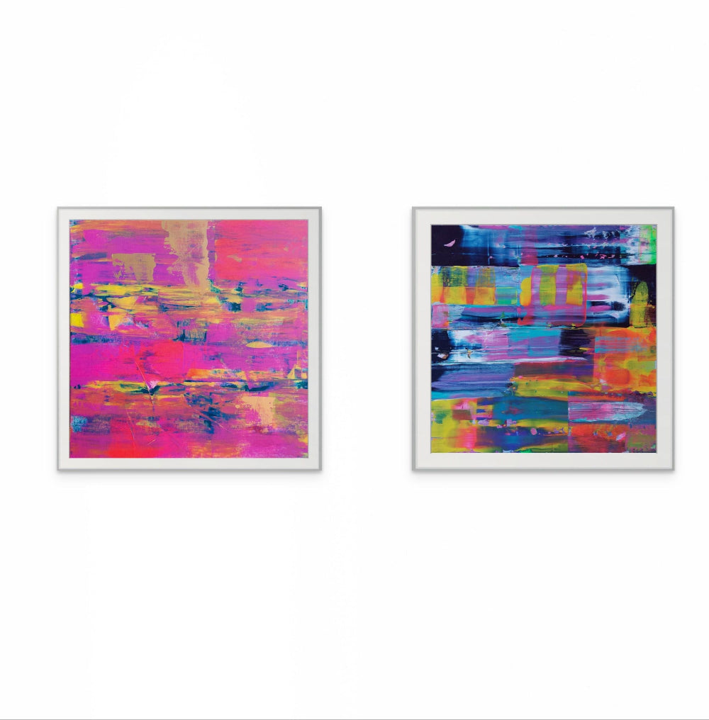 Two abstract art pieces in white frames on a white background