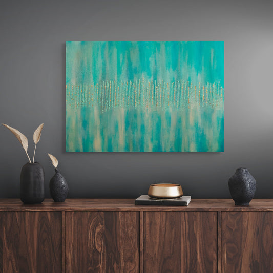 Abstract teal painting on a gray wall above a wooden console table with decorative items. titled Golden Forest by Julie Bevan