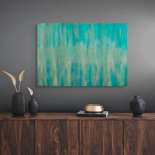 Abstract teal painting on a gray wall above a wooden console table with decorative items. titled Golden Forest by Julie Bevan
