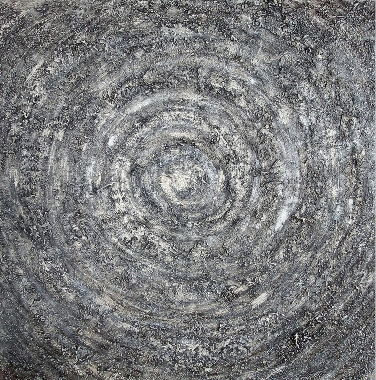 Close-up of a stone surface with concentric circular patterns