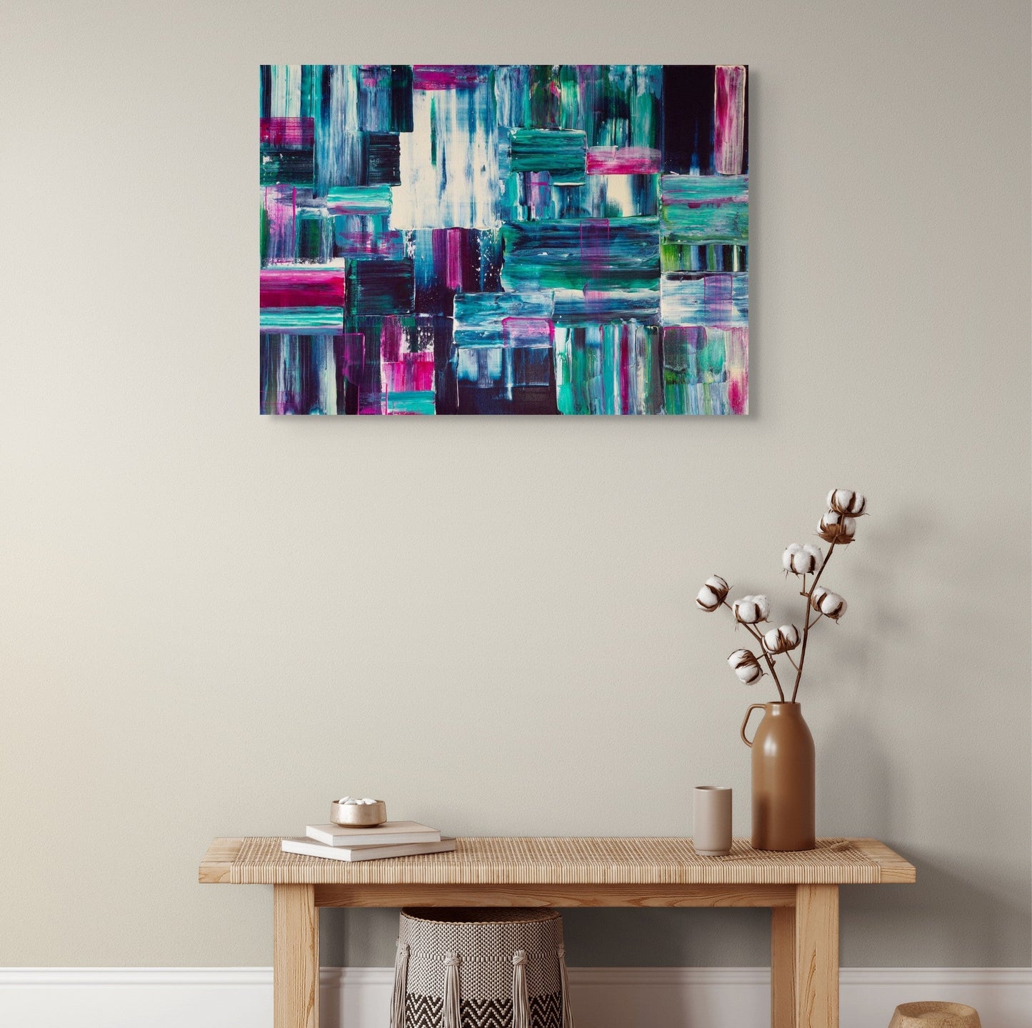 Abstract painting on a wall above a wooden bench with decorative items.