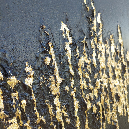 Close up Black textured painting with gold leaf overlay