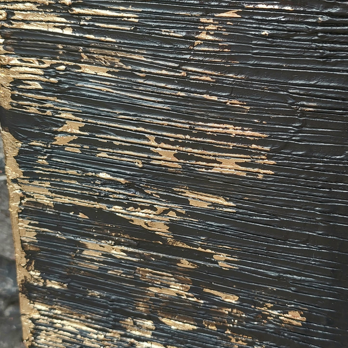 Close up of Black and gold textured painted canvas
