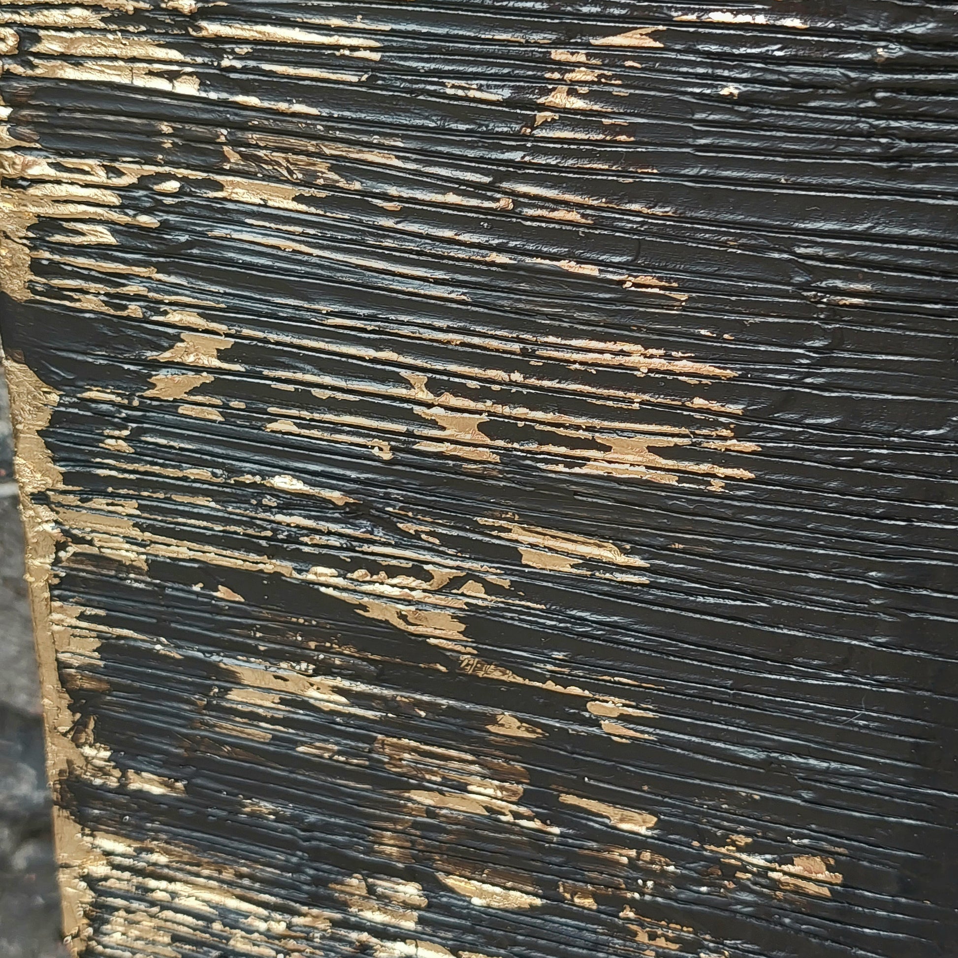 Close up of Black and gold textured painted canvas