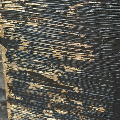 Close up of Black and gold textured painted canvas