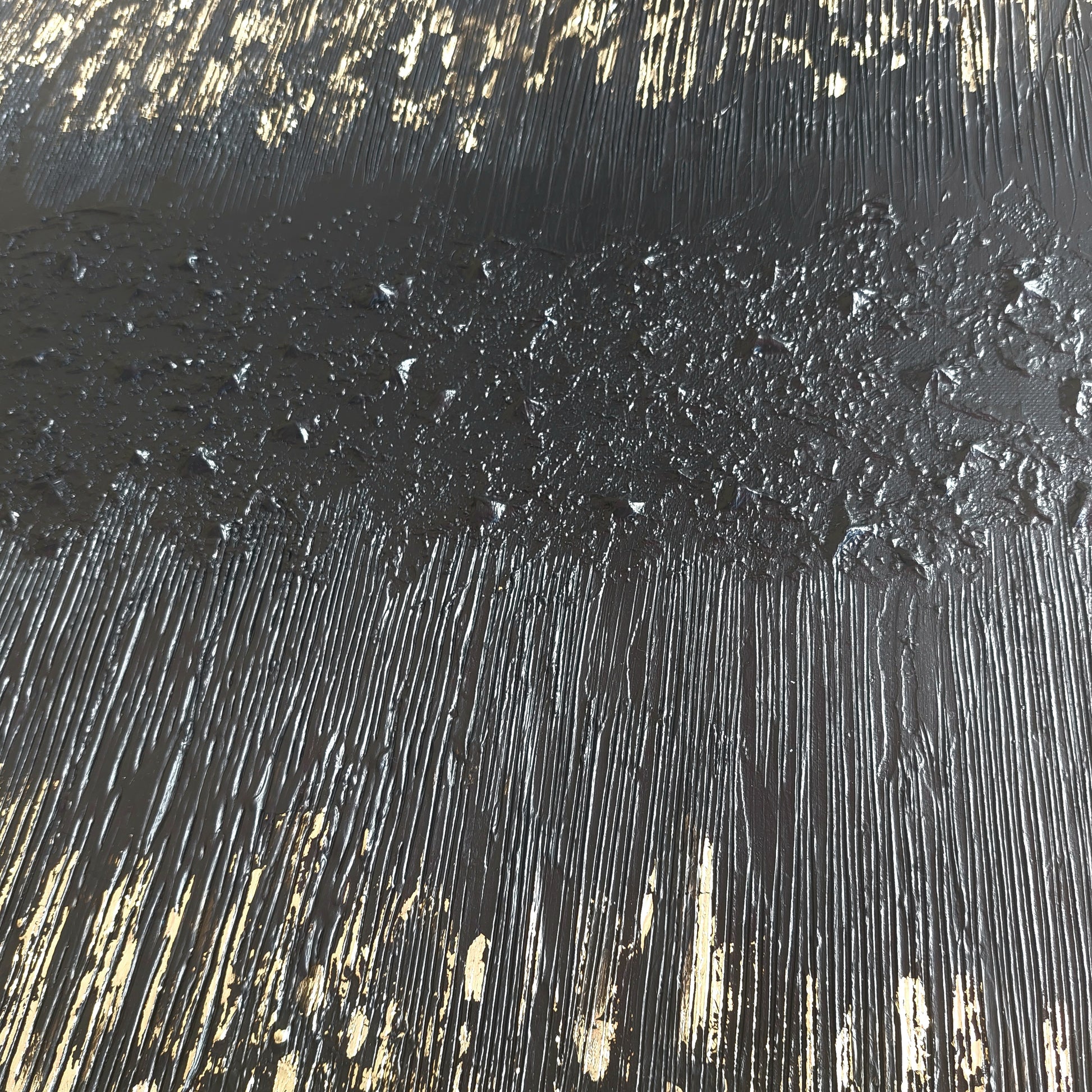 Close up of Black and gold textured painted canvas