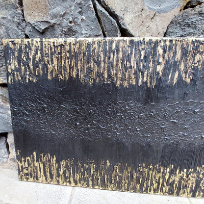 Close up of Black and gold textured painted canvas