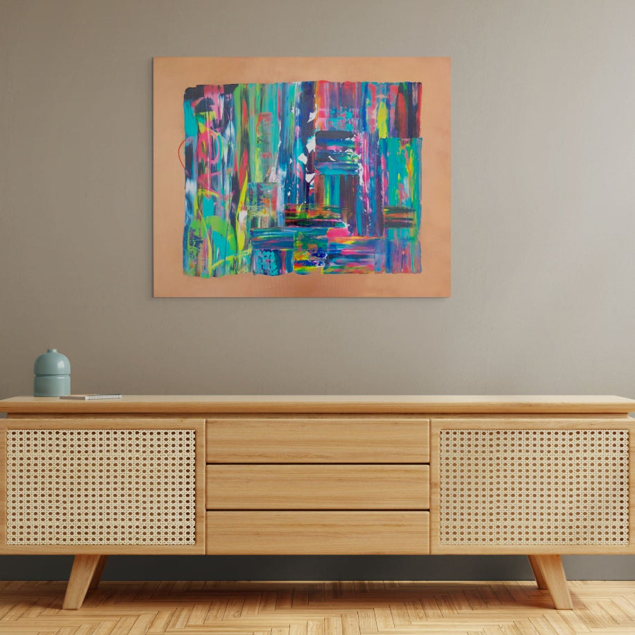 Wooden sideboard with wicker doors against a gray wall with a colorful abstract painting. Tao an original abstract canvas painting by Julie Bevan