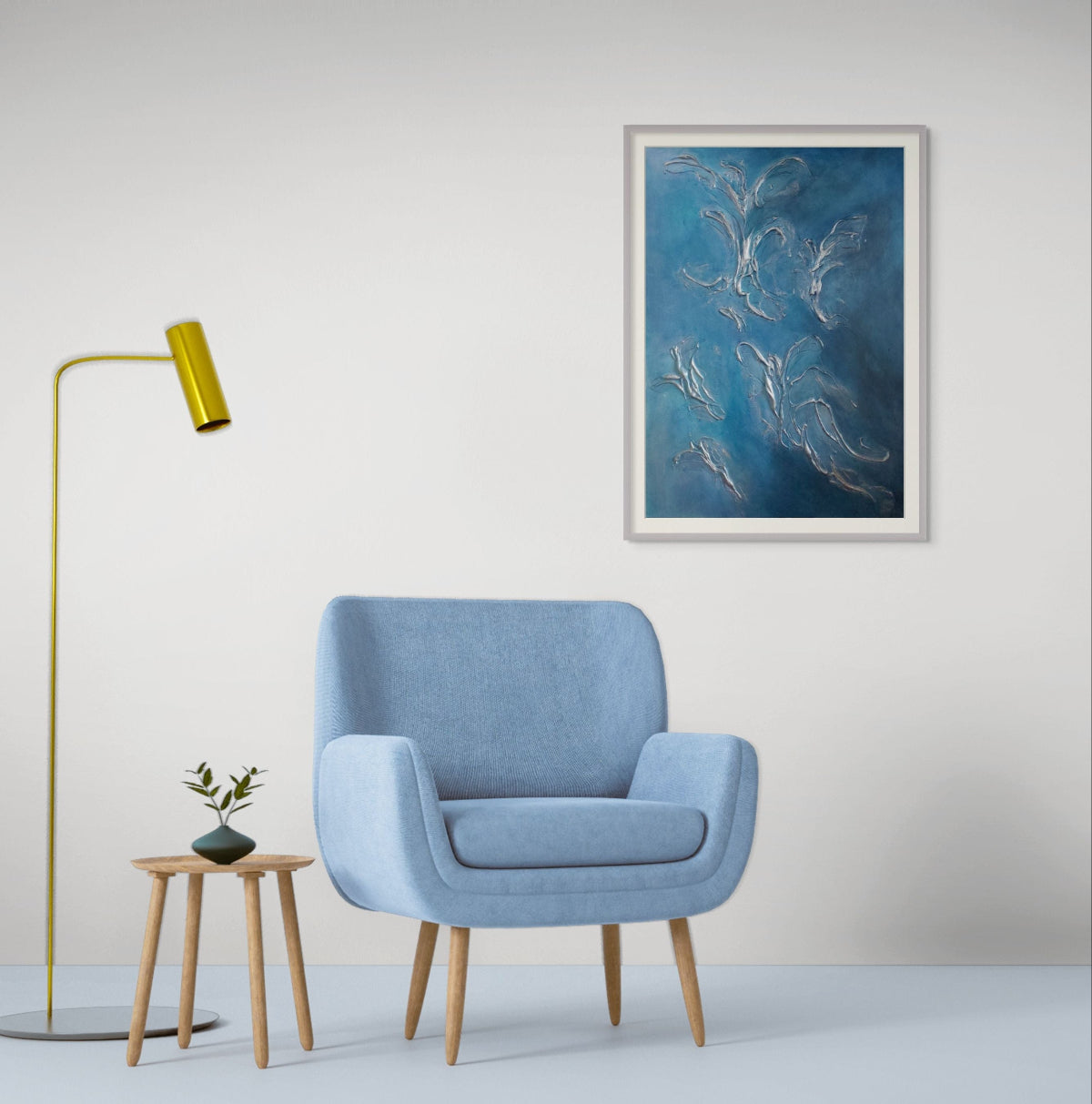 Blue armchair in a room with a gold floor lamp, small table, and blue abstract limited edition print artwork