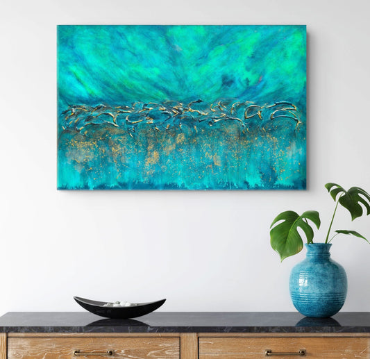 Abstract canvas wall art featuring vibrant turquoise, teal, and green textures with shimmering gold accents, displayed on a white wall above a wooden console table with a blue vase and green plant. Equinox, Original Canvas Painting by Julie Bevan