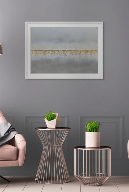 Modern living room with side tables, potted plants, and a framed artwork on a gray wall.