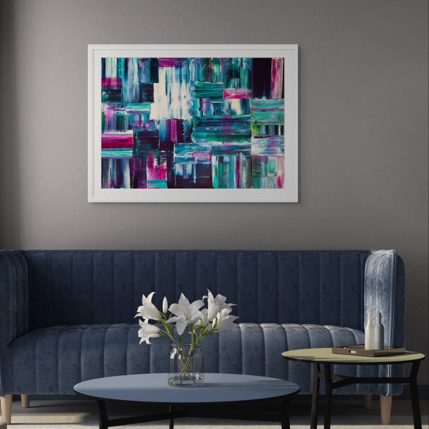Modern living room with a blue sofa, coffee table, and abstract art on the wall.