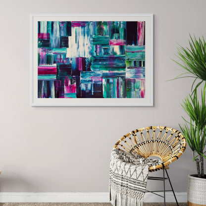 Abstract art piece on a wall above a chair with a plant in the corner.