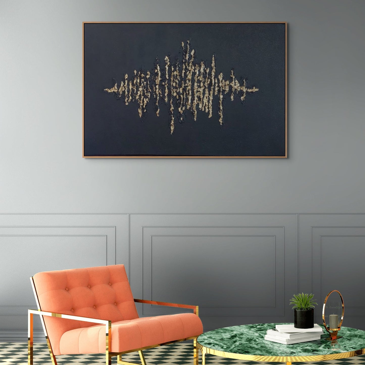Black textured painting with gold leaf overlay hanging over peach and gold chair
