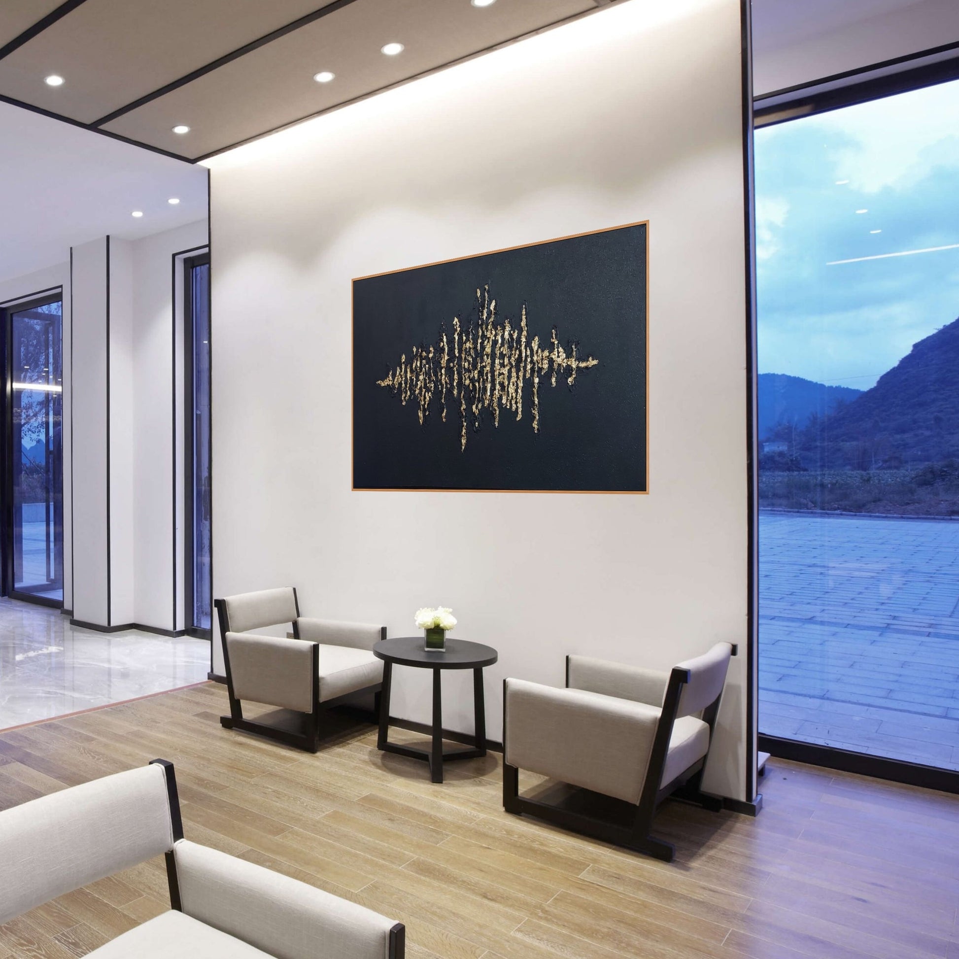 Black textured painting with gold leaf overlay in a hotel lobby