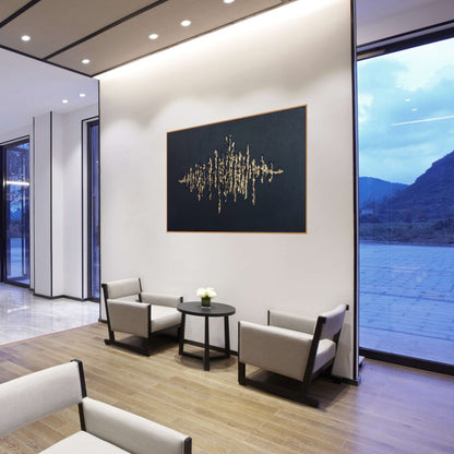 Black textured painting with gold leaf overlay in a hotel lobby